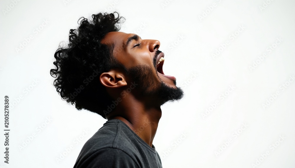 Obraz premium Young black man screams loud with open mouth, head tilted back. African guy expresses strong emotion sings passionately. Male portrait isolated on clean white background. Person shows intense