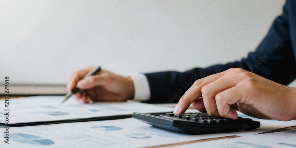 Fototapeta premium Business professional using calculator for financial analysis