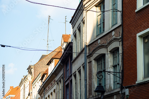 Photos A row of historic European city townhouses features diverse facades and classic rooflines under a bright sky