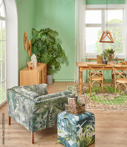 Green living room and wall background concept, wooden furniture, table, chair vase of plant and brown parquet style.
