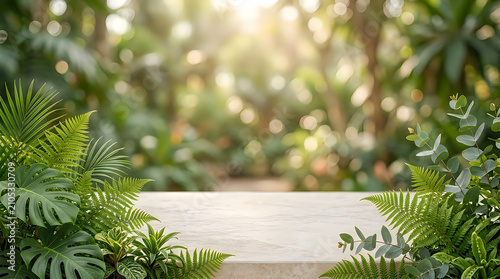 Empty stone table top with tropical plants and leaves in a lush green garden with soft sunlight bokeh background for product display