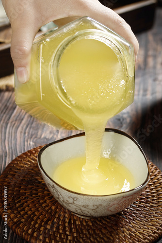 Canvastavla Pouring Golden Honey from Glass Jar into Bowl - Natural Organic Sweetener