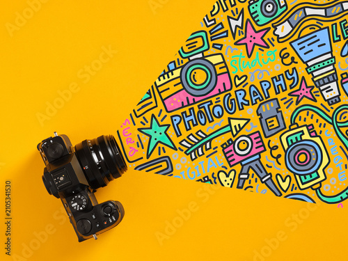 Camera creating colorful photography doodles on yellow background