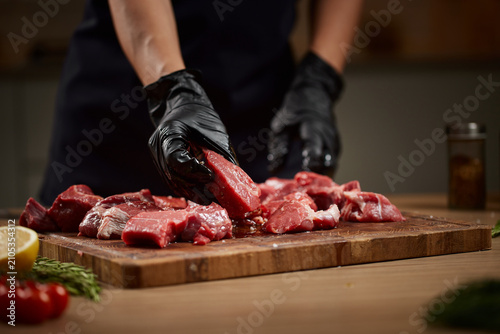 Obraz na płótnie Chef preparing raw beef meat for cooking