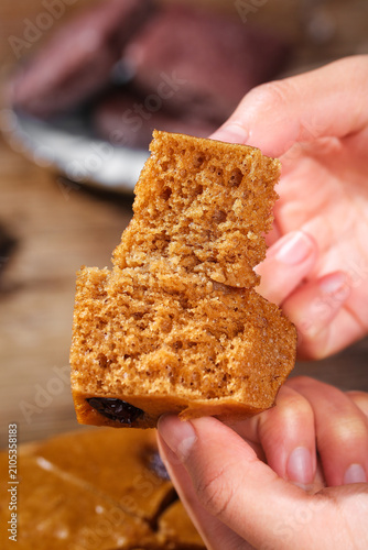 Bild auf Leinwand Golden Brown Honeycomb Toffee Candy with Airy Texture Held in Hands - Sweet Conf
