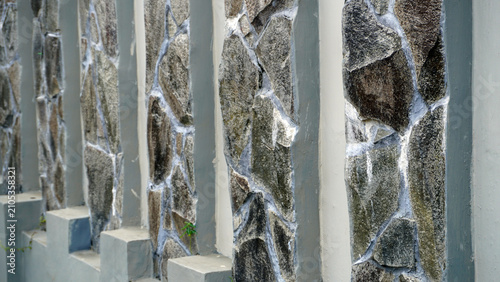 Photos Decorative stone wall fence with white cement joints.