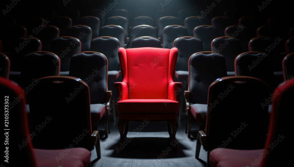 Fototapeta premium Red chair in dark theater among empty seat, dramatic spotlight, cinematic interior, lonely concept, red upholstery
