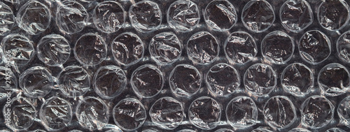Close-up of transparent bubble wrap plastic texture used for protective packaging and cushioning fragile items during shipping and storage.