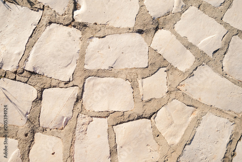 Irregular natural stone wall texture with rough pieces