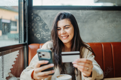 Woman shopping online with credit card and smartphone