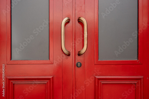 Cuadro en lienzo Double red wooden doors with brass handles and frosted glass panels