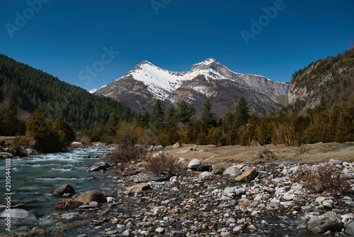 Canvas Print The Bujaruelo Valley, through which the Ara River flows, along with the mountains, the meltwater from the Aragonese Pyrenees, the Ordesa and Monte Perdido National Park, the Pyrenees, and Huesca