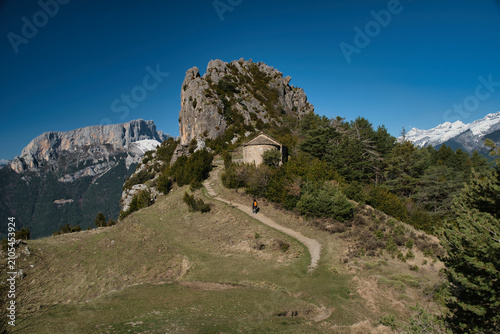 A young girl hiking up to the Chapel of San Juan and San Pablo in Tella, Huesca, located in the Aragonese Pyrenees.