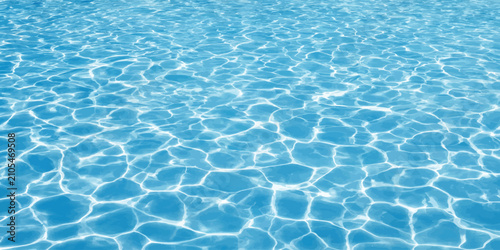Obraz na płótnie Crystal clear swimming pool water surface with sun reflection patterns swimming