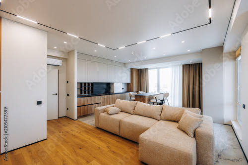 Konstfotografi Modern open plan living room with neutral sectional sofa, integrated minimalist