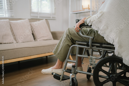 Senior woman sitting in a wheelchair at home, highlighting mobility support, independent living, rehabilitation, and elderly home care.