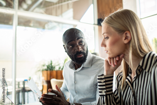 Two business colleagues discussing project in modern office