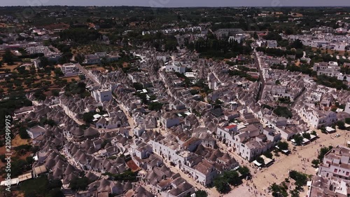 Scenic aerial view of the historic trulli houses of alberobello, puglia, showing the unique conical roofs and whitewashed walls of this famous unesco world heritage site