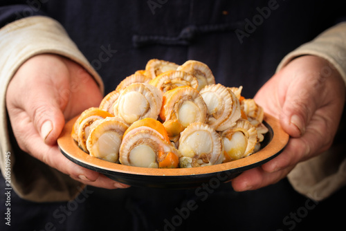 Canvastavla Fresh Raw Scallops with Yellow Fan Shells Held in Hands - Premium Seafood Ingred
