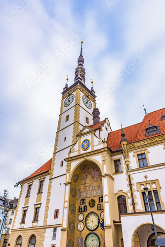 Low angle view of the historic Olomouc Town Hall with its high clock tower and astronomical clock in Czechia.