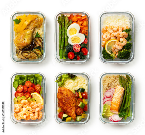 Weekly meal prep with six homemade lunch boxes arranged in a two row on a white background. Healthy balanced meals chicken, egg, seafood, fish, vegetables, quinoa, couscous, barley, and rice. 