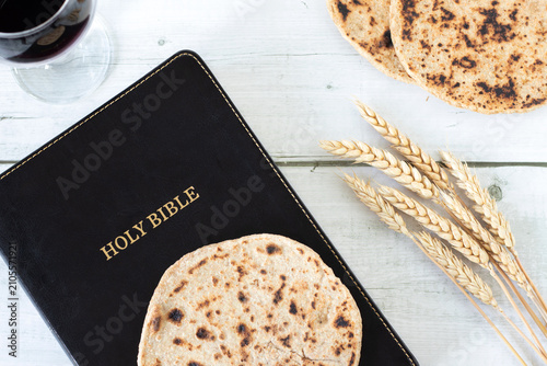 Принти на полотні Unleavened bread, holy bible, wheat and a glass of wine on wooden table