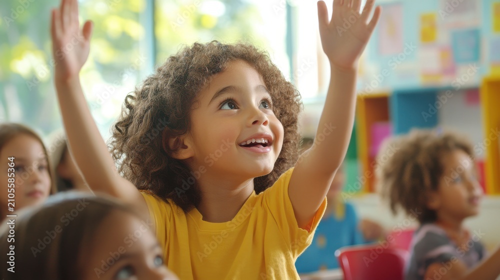 Fototapeta premium Happy elementary student with hand raised in classroom