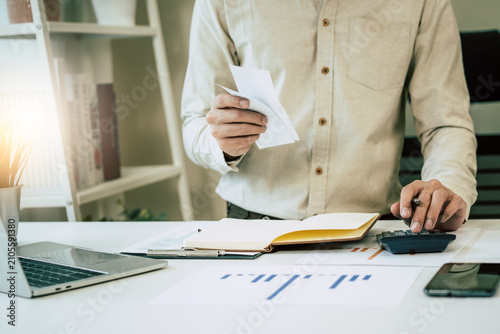 Принти на полотні Deduction planning, debt asian accountant hand using calculator to calculating money balance from bill and income, cost budget expenses for pay money form personal individual on table at home
