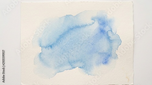Abstract watercolor paint splash background in soft blue tones. Ethereal ink diffusion texture for creative design and elegant decor
