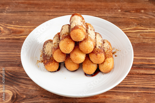 Konstfotografi Crispy Churros Stack on White Plate