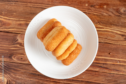 Fotografie Stack of Sugar-Coated Fried Pastries on a White Plate