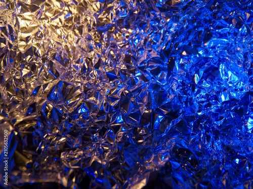 Photography Metal foil surface with reflections under light showing shades of blue and gold