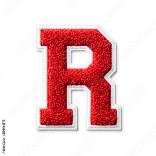 Close-up of a high-contrast red velvet letter R patch with white stitching, isolated on white background. Studio lighting emphasizes texture and depth for commercial use.