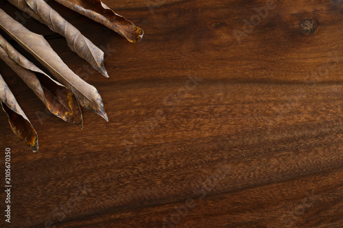 Dried leaves Wooden table Copy space