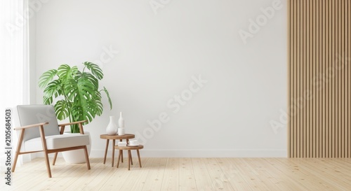 Minimalist living room interior with armchair, monstera plant, and blank white wall mockup for art.