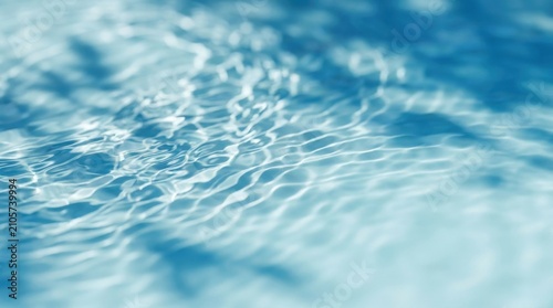 Close up of clear blue water surface with ripples and light reflections.