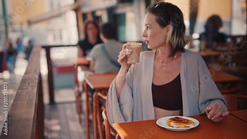Young woman drinking coffee outdoors