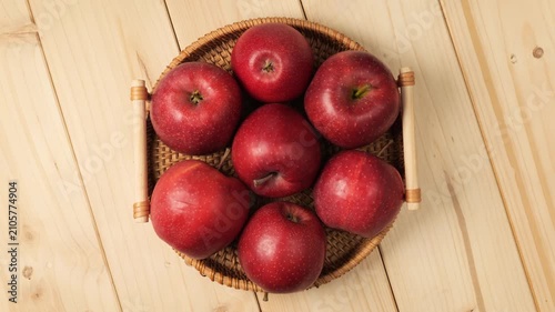 Wicker basket of fresh red apples rotating