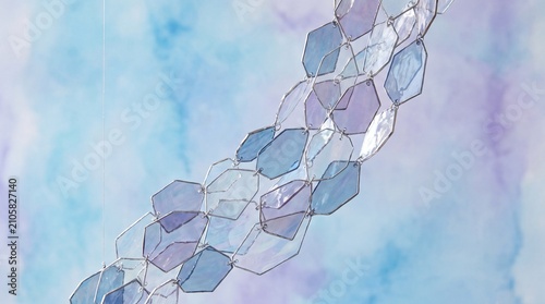 Elegant abstract composition of transparent geometric glass shards on a soft blue and purple gradient background