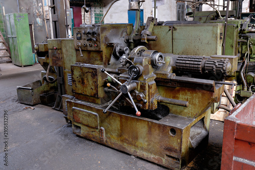 Obraz na plátně Old vintage metalworking lathe machine and industrial equipment inside heavy industry factory workshop setting