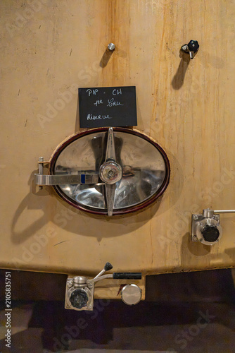 Foto Stainless steel wine tank with a valve in a champagne cellar