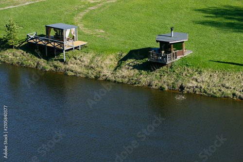 Two Riverside Retreat Buildings on a Sunny Summer Day