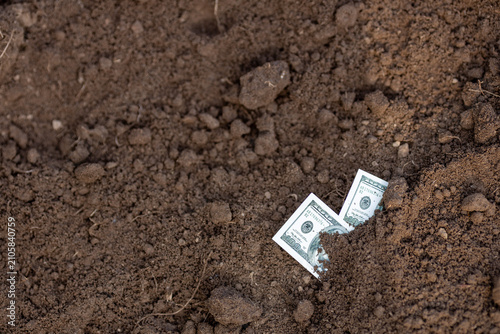 Fotografie Two Hundred-Dollar Bills Buried in the Ground Economic Crisis
