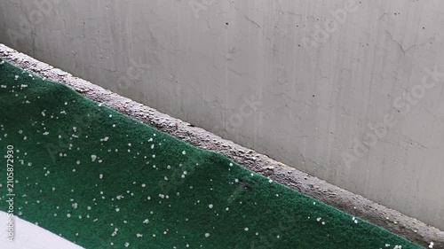 Heavy Hail Falling on a Green Artificial Grass Carpet