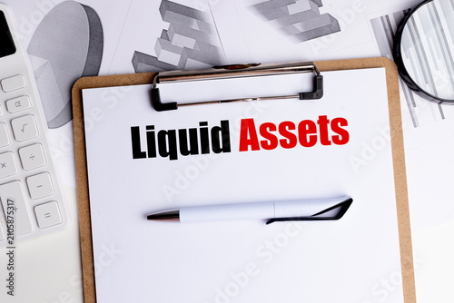 Картината върху платно Liquid assets concept with clipboard financial reports calculator and pen repres