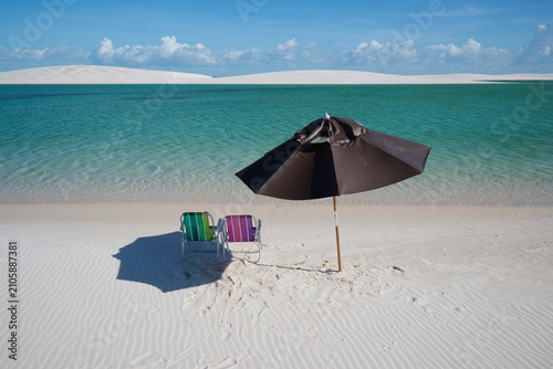 Lagoon with umbrella and chairs in Lencois Maranhenses