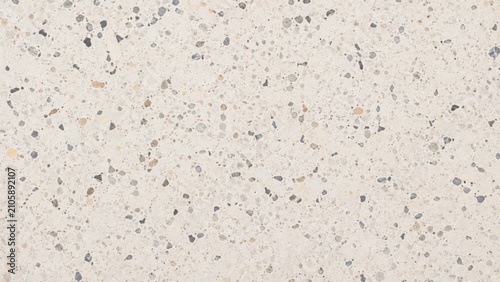 A high resolution close up of light beige terrazzo flooring with small stone chips