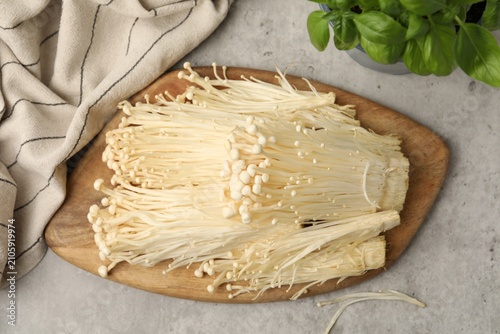 Canvastavla Raw enoki mushrooms, basil and towel on grey table, flat lay