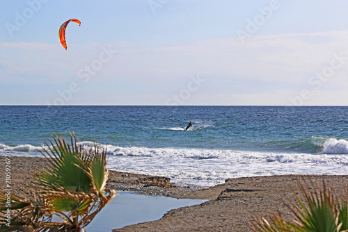 kitesurfer riding his board on the sea	