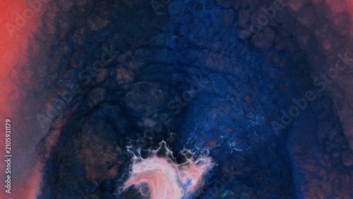 Mixing fragments of alcohol ink on a surface in an art studio